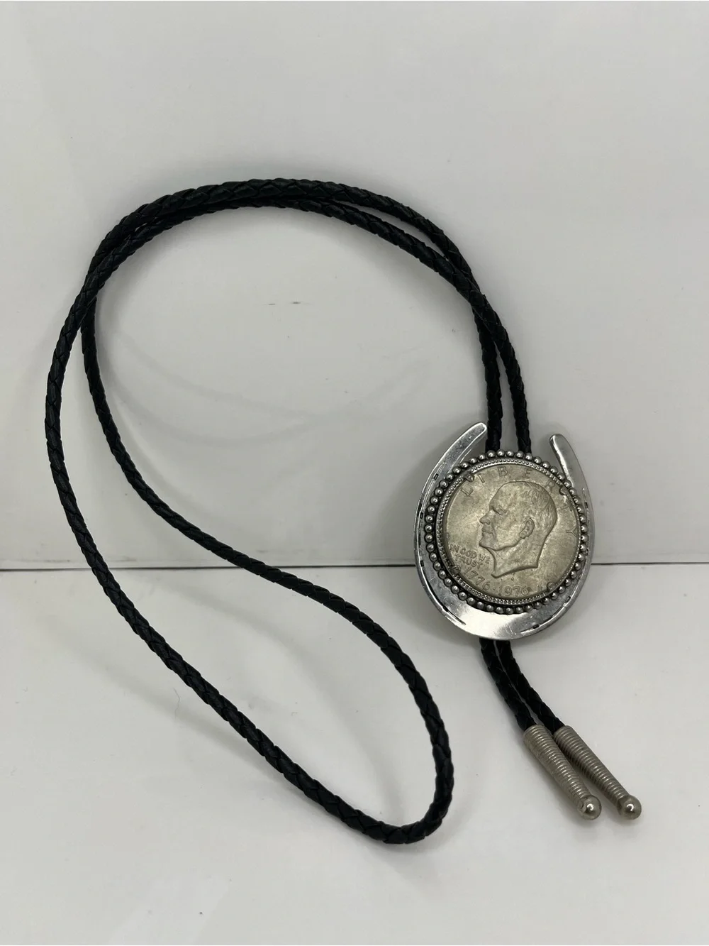 Black Braided Leather Bolo Tie with Silver Horseshoe and Coin Medallion
